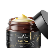Tallow Schwarzkümmel+ Hautpflege mit Mandel-Duft, 100 ml im braunen Glastiegel mit geöffnetem schwarzem Deckel, sichtbarer heller Creme und Gras-gefüttert-100-%-Qualität-Hinweis auf grauem Hintergrund.
