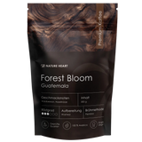 Schwarze 500-Gramm-Packung Nature Heart Forest Bloom Single-Origin-Espresso aus Guatemala mit feinen Geschmacksnoten von Waldbeeren und Haselnüssen.